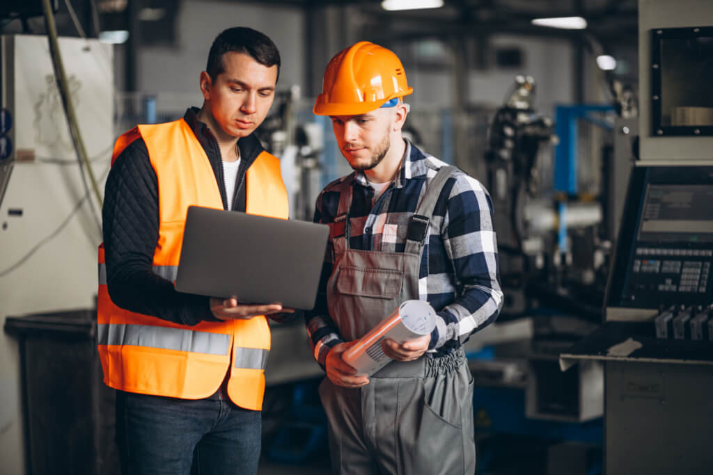 Engineers discussing over laptop