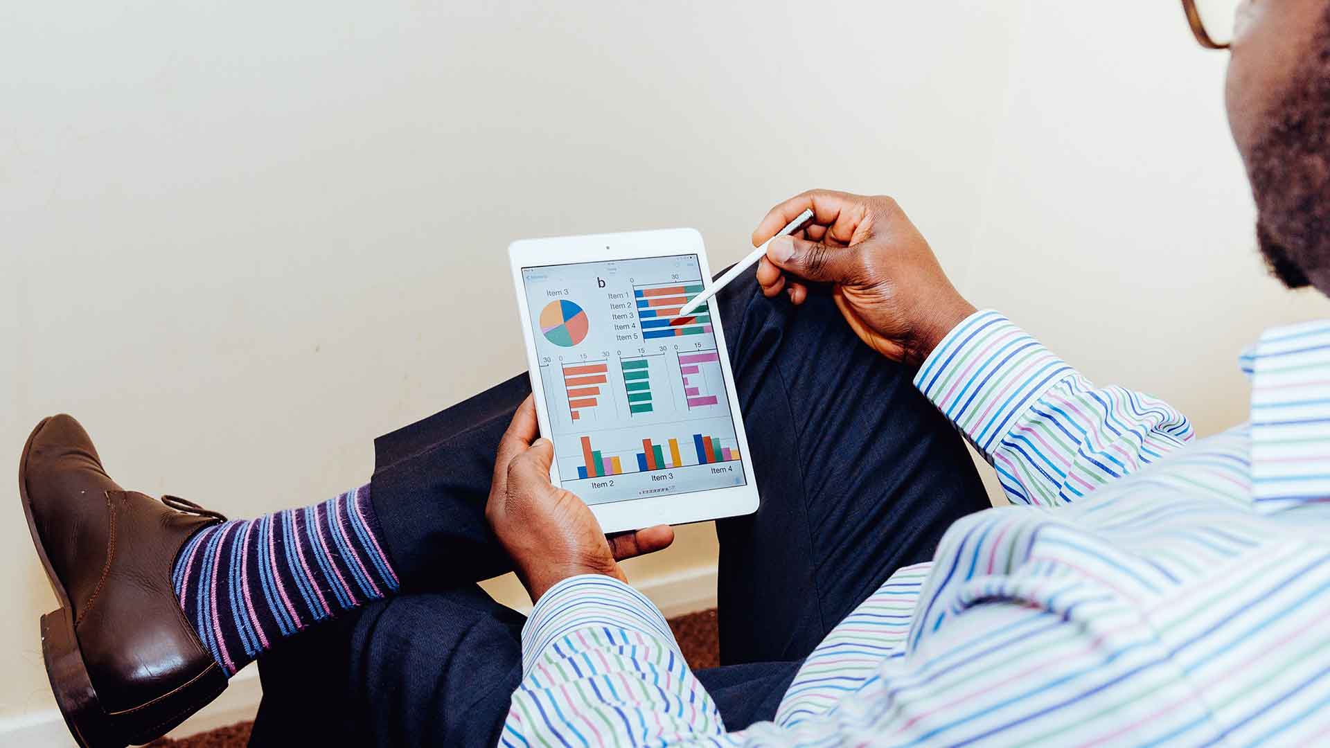 Person viewing charts on a tablet